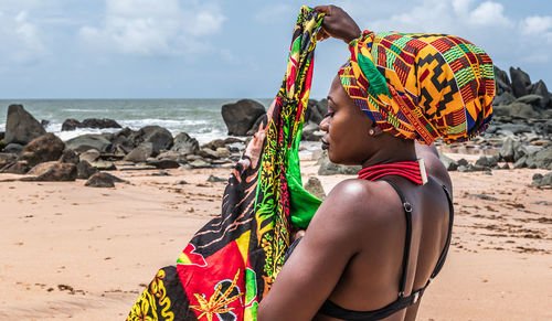 Ghana woman walking around on the beautiful beach of axim, located in ghana west africa