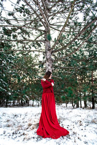 Woman standing on snow covered land