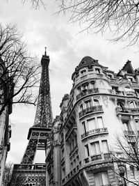 Low angle view of buildings against cloudy sky