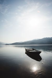 Boat in calm sea against sky