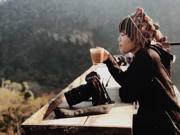 Side view of a man holding drink