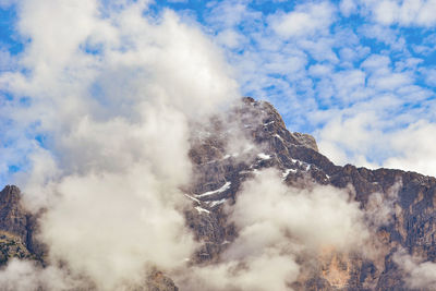 Low angle view of smoke on mountain against sky