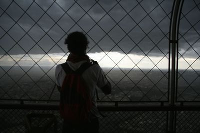 Man standing by railing