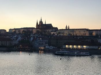 Bridge over river against buildings in city