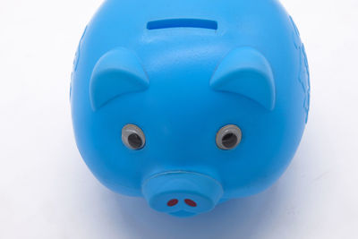 Close-up of blue toy over white background