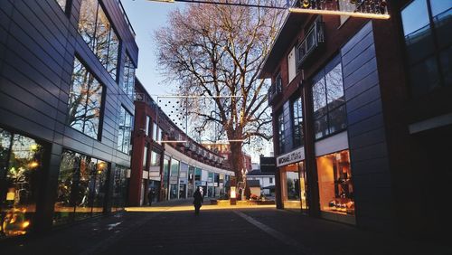 People walking on street amidst buildings in city