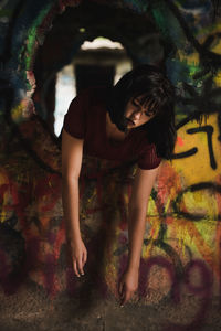 Portrait of young woman sitting outdoors