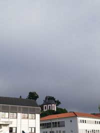 Buildings in town against clear sky