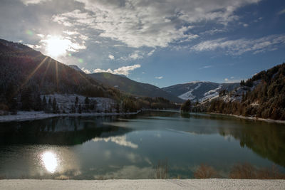 Scenic view of lake and mountains against sky