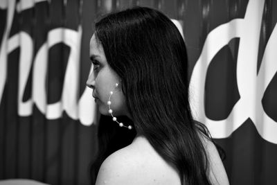 Woman looking away while standing outdoors