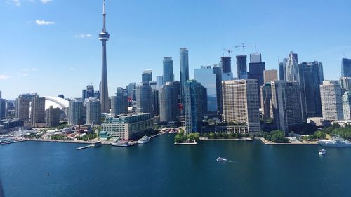 Cityscape by lake ontario against sky