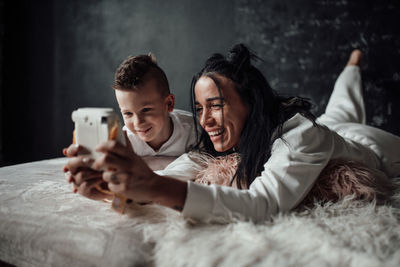 Portrait of smiling young man using smart phone