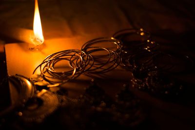 Close-up of illuminated lamp on table