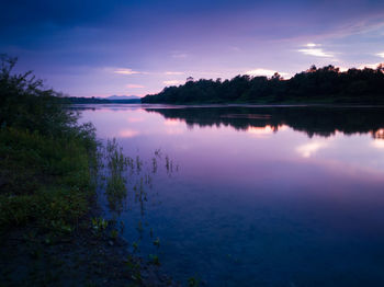 Scenic view of lake against sky at sunset