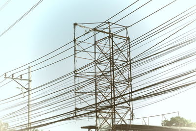 Low angle view of electricity pylon against sky