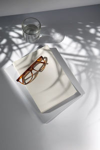 High angle view of eyeglasses on glass table