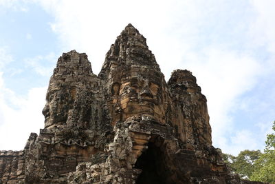 Low angle view of rock formations against sky