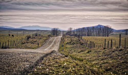 Road amidst landscape against sky