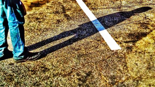 Low section of man standing on tiled floor