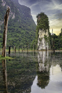 Scenic view of lake by trees against sky