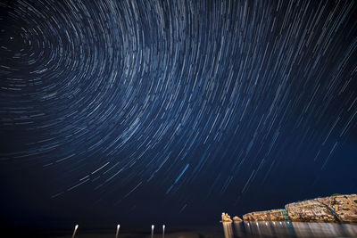 Low angle view of fireworks against sky at night