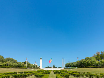 Scenic view of beach against clear blue sky