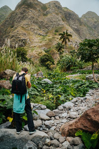 Rear view of man standing on mountain 