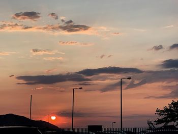 Low angle view of silhouette street against sky during sunset