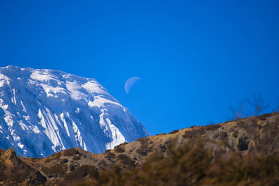 Scenic view of mountains against clear blue sky