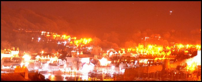 Illuminated lights against sky at night