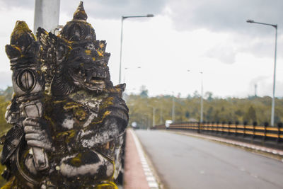 Close-up of statue against road