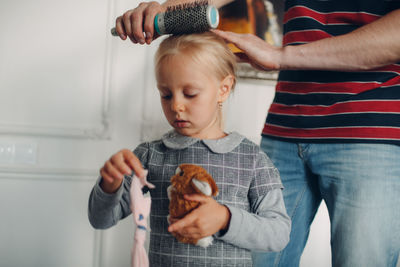 Midsection of mother holding baby at home