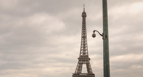 Low angle view of tower against cloudy sky