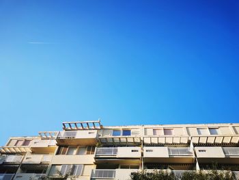 Low angle view of building against clear blue sky