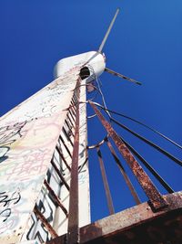 Low angle view of crane against blue sky