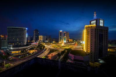 Illuminated buildings against sky at night