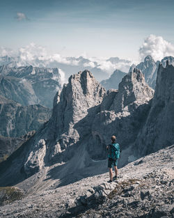 Man standing on mountain against sky