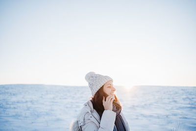 Portrait of woman against sea against clear sky