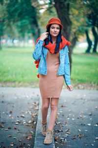 Portrait of woman standing at park