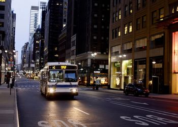 View of city street and buildings at night