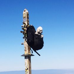 Low angle view of statue against clear blue sky