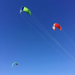 Low angle view of hot air balloons against blue sky