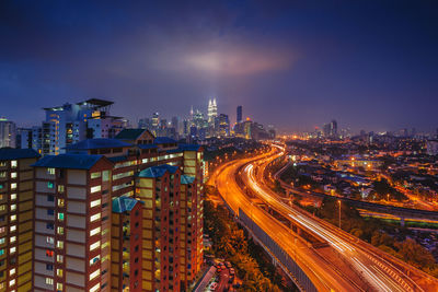 High angle view of light trails on highway at night