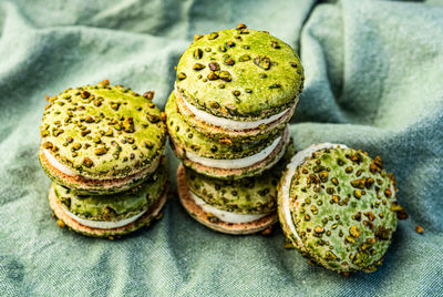 Stacks of green color pistachio macaron cream filled sandwich cookies