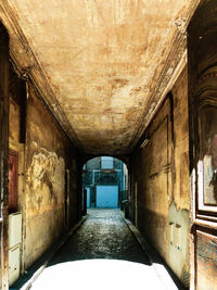 Empty narrow corridor along old building