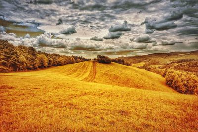 Scenic view of landscape against cloudy sky