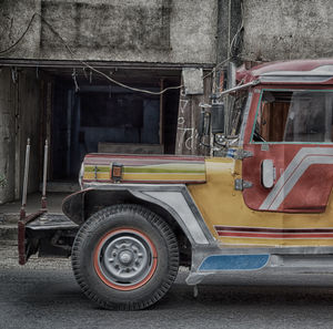 Vintage car parked on road in city