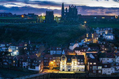 High angle view of illuminated buildings in city at night