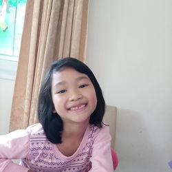 Portrait of smiling girl at home