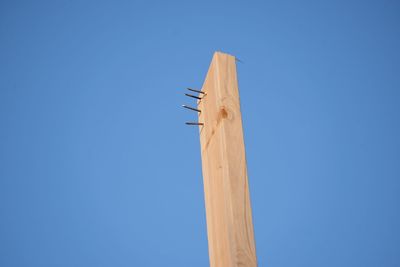 Low angle view of airplane against clear blue sky